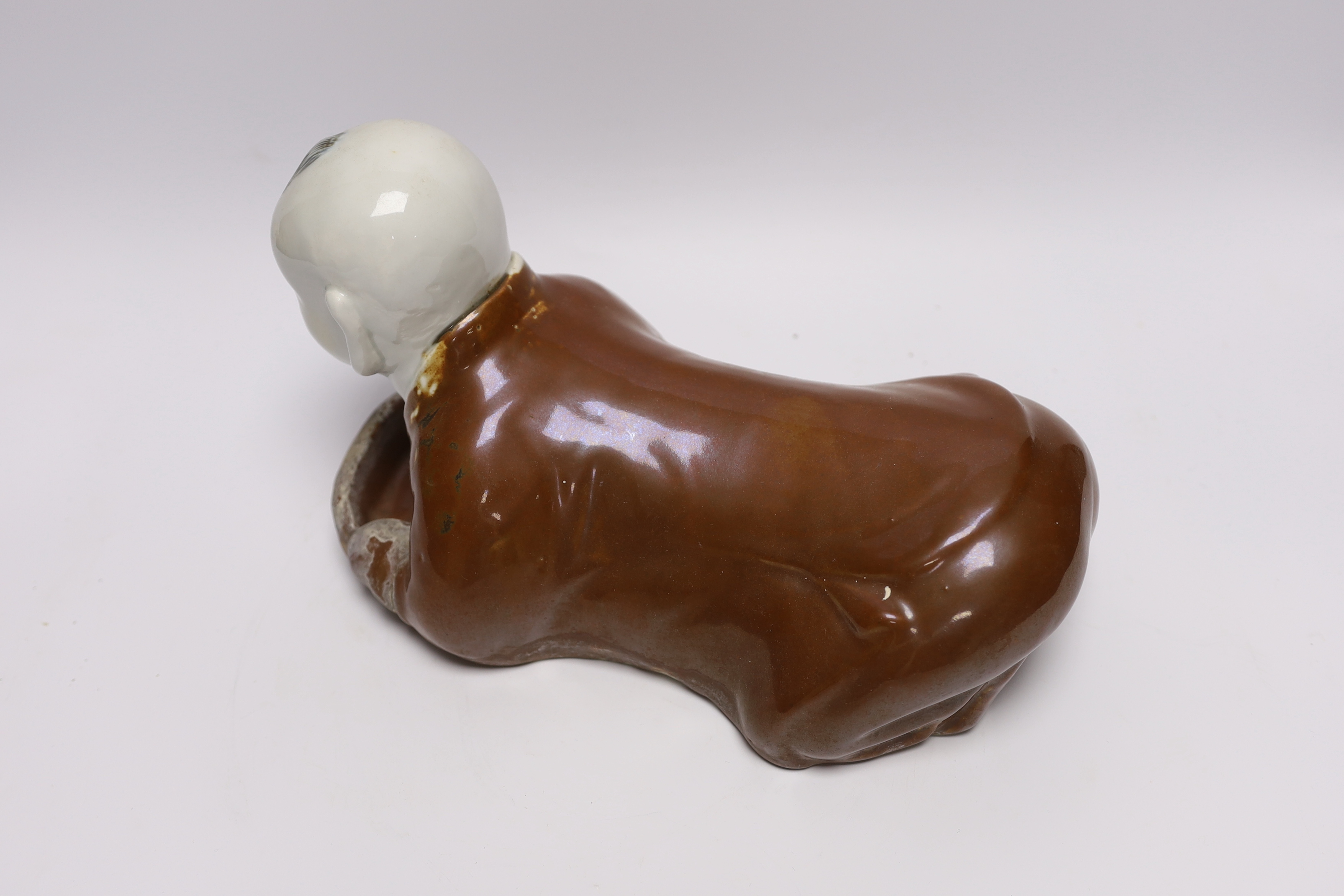 A Chinese porcelain ‘boy’ headrest, 29cm long